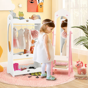 Child playing with a toy wardrobe and mirror in a room with colorful decor.