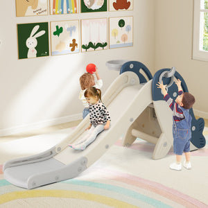 Children playing on a slide in a room with colorful decorations.
