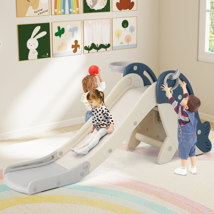 Children playing on a slide in a room with colorful decorations.