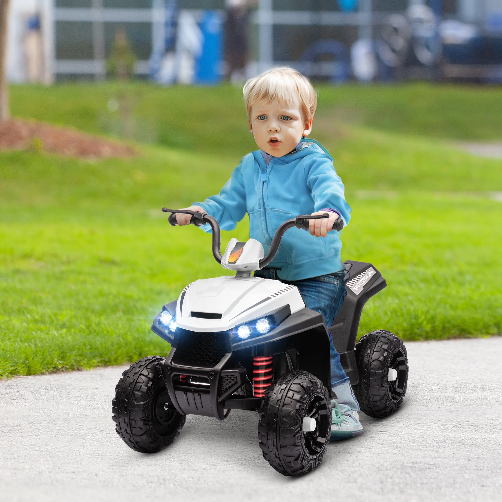 Front view of white kids ATV showing realistic LED lights and rugged wheels