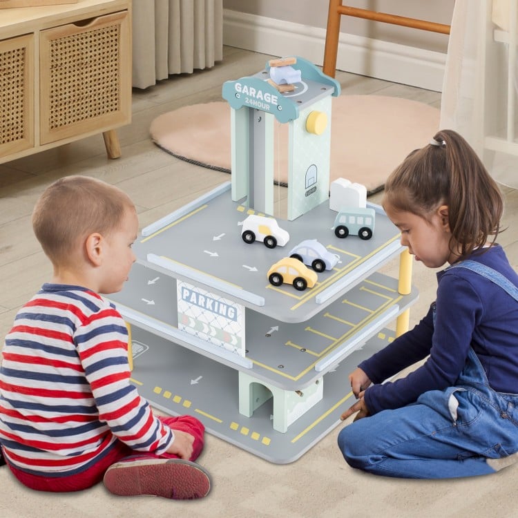 Front view of 3-level wooden parking garage playset with cars and helicopter