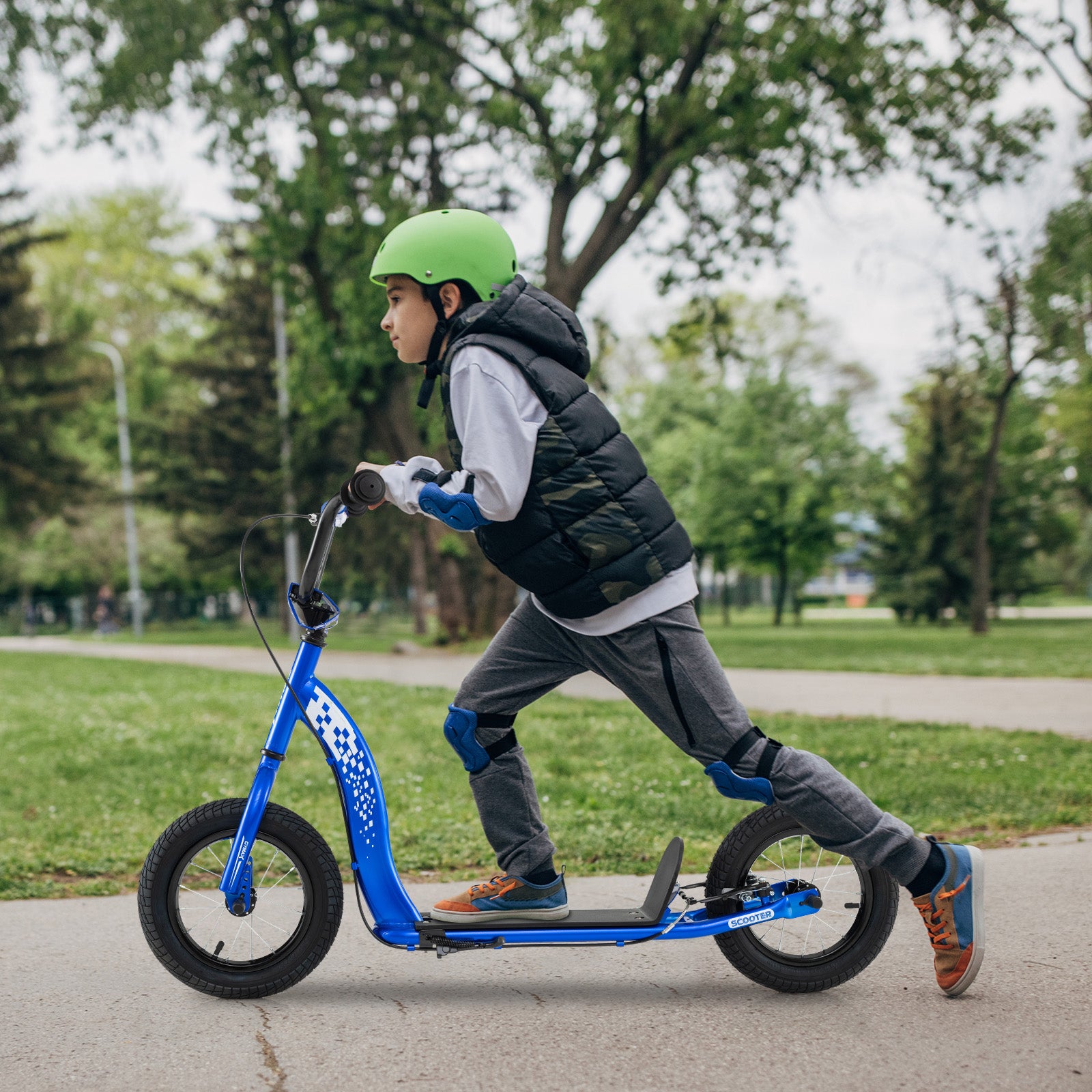 Child riding a blue scooter in a park with trees and grass in the background